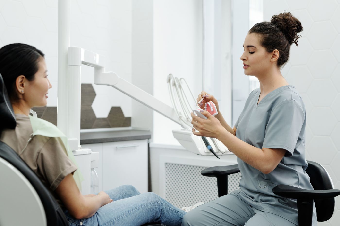 Dentist discussing a planned treatment with a patient.