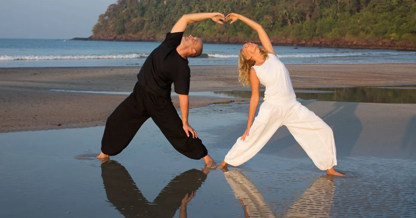 Yoga practice on the beach photographed by Nalanda Retreat.